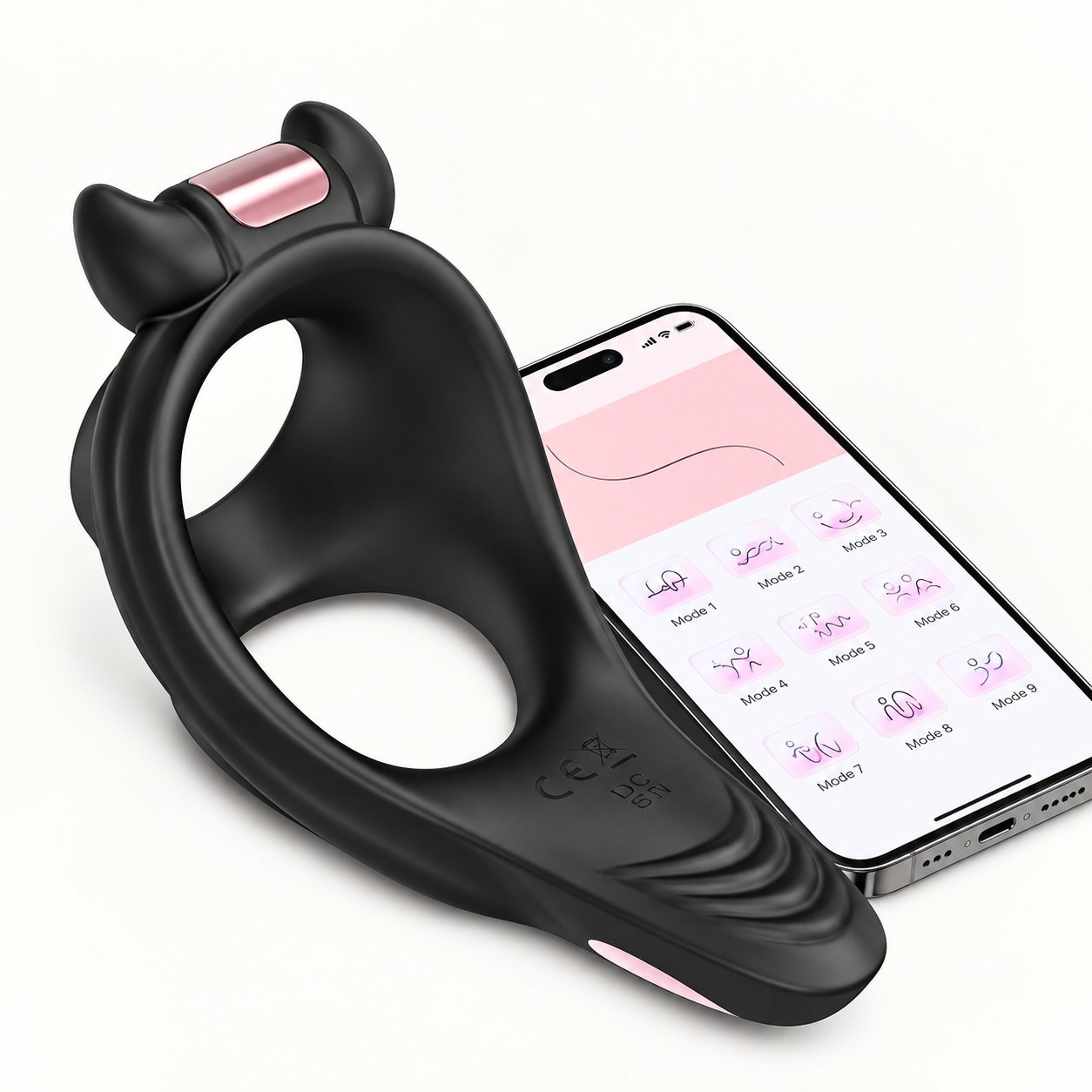 WY0607 Alan app-controlled cock ring with decorative cat-ear top and rose-gold accent, paired with phone showing pink-themed app modes