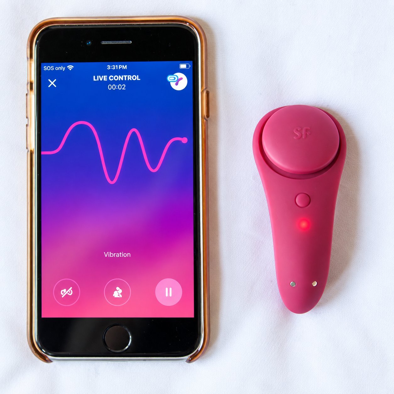 Pink teardrop-shaped vibrator beside an iPhone running a Live Control vibration waveform screen