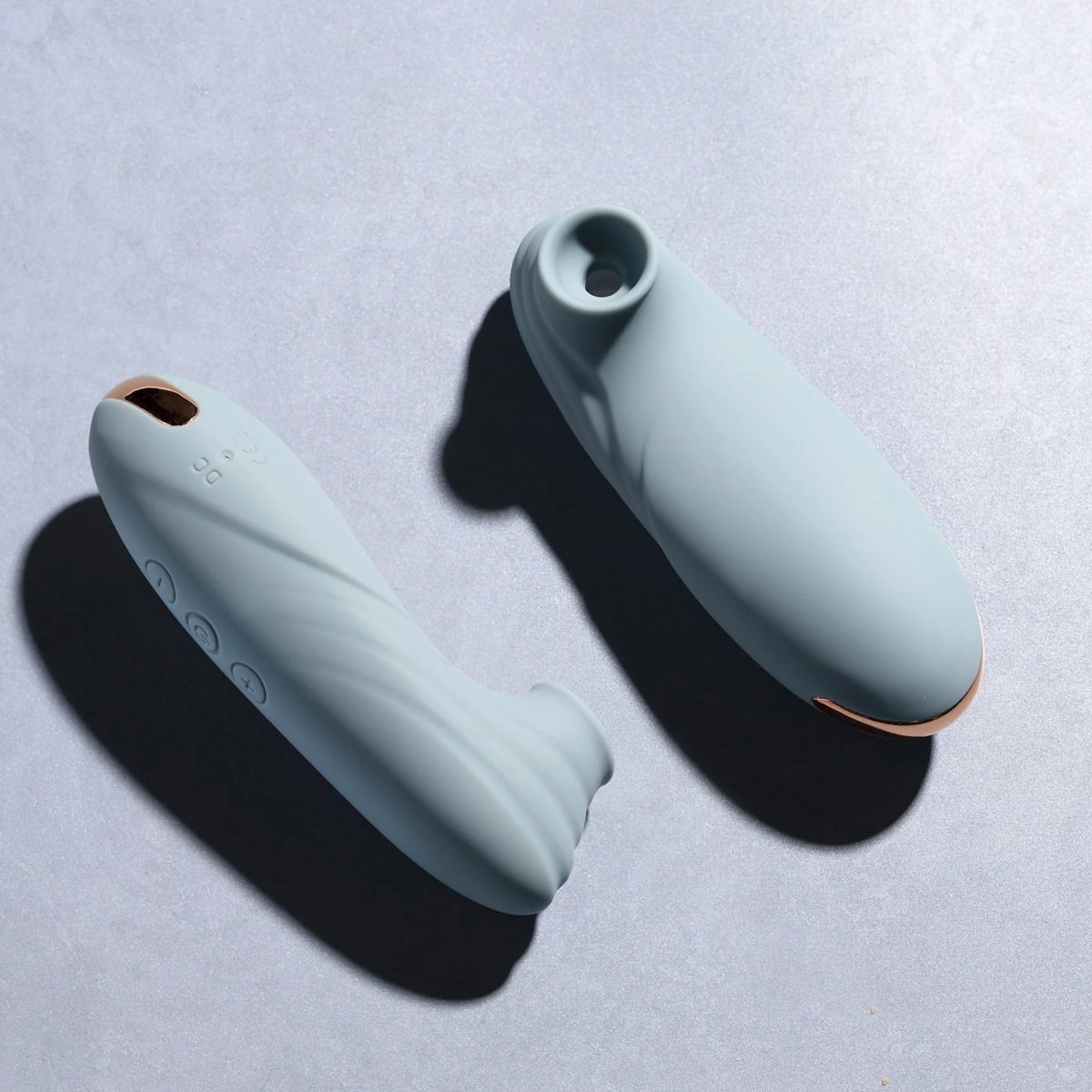 Top-down view of two clitoral suction stimulators showing silicone rim and base