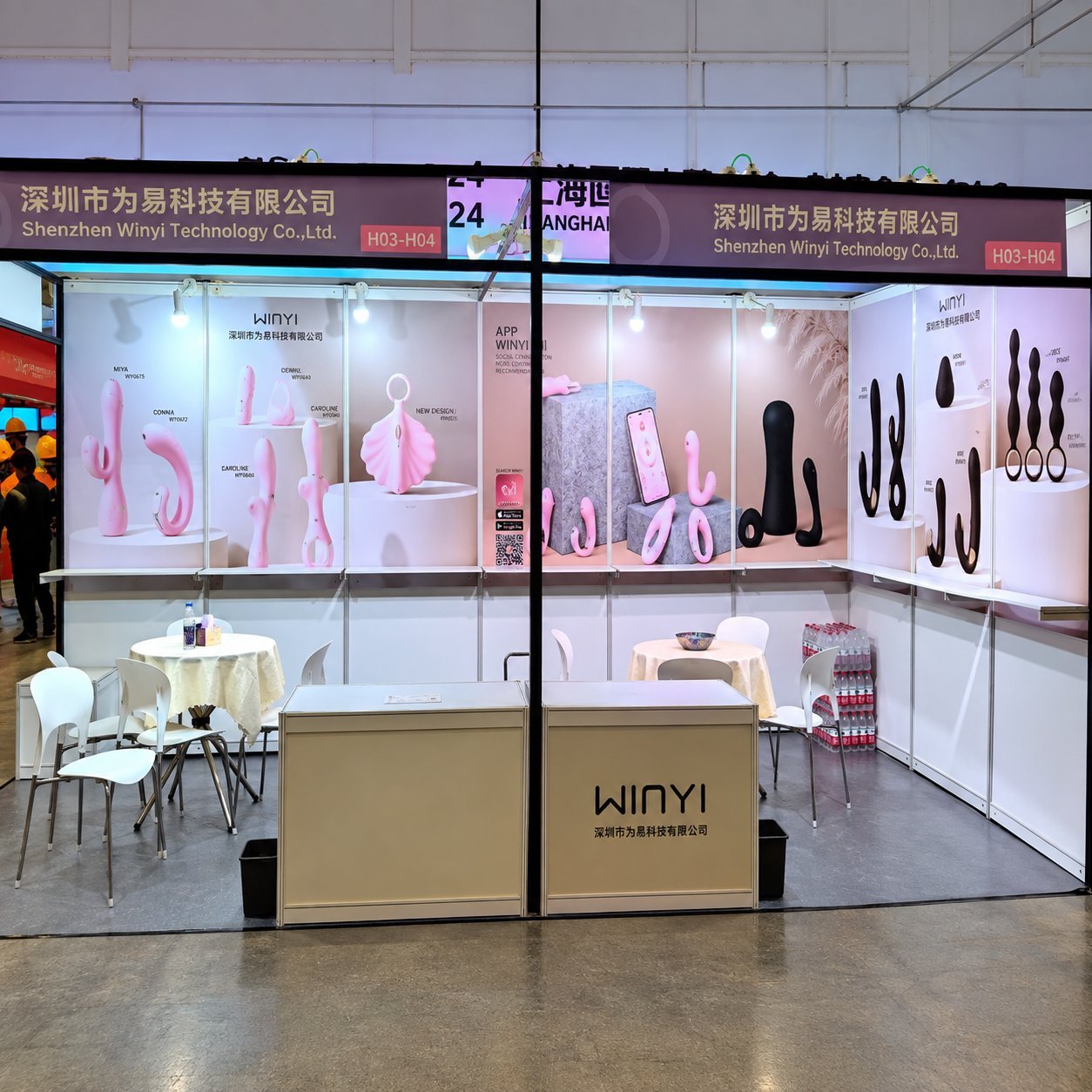 WINYI booth at Shanghai APIEXPO with H03-H04 booth number banner, pink and black product displays including APP-controlled WINYI social-connection toys