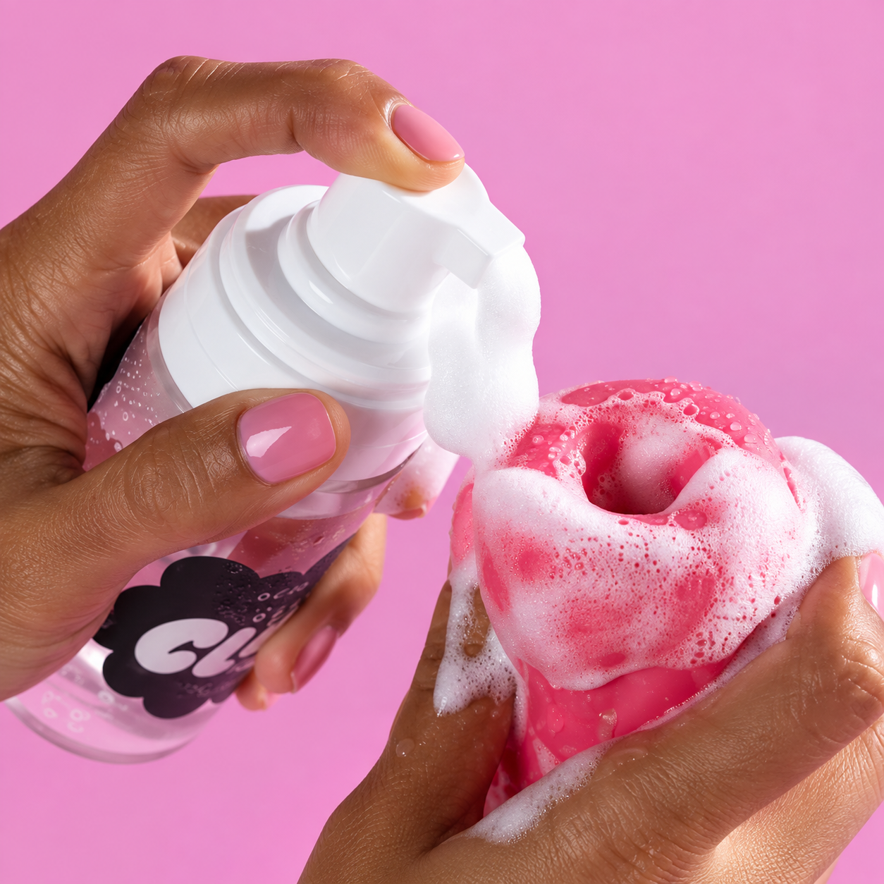 Foam cleaner applied to a pink adult toy for cleaning