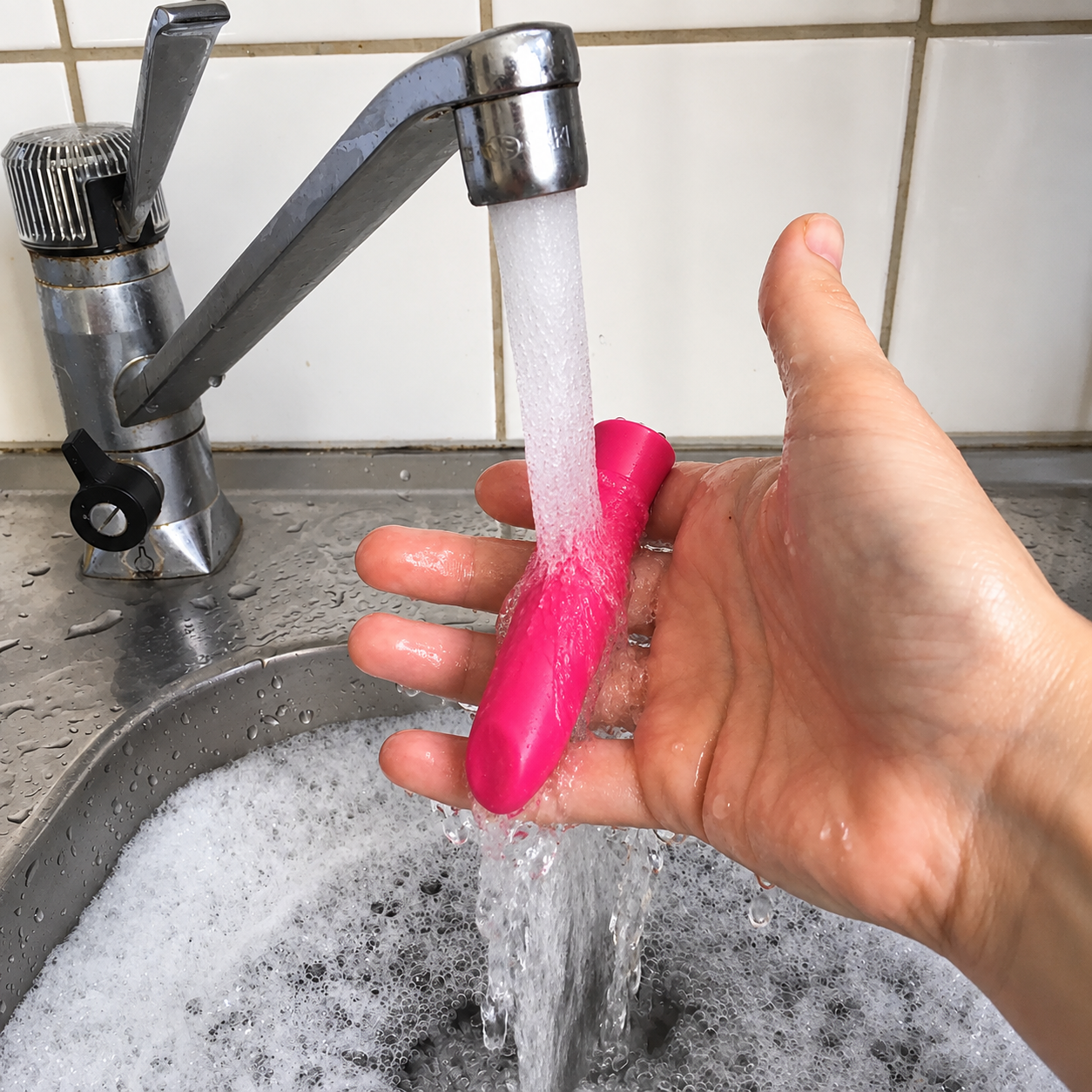 Motorized adult toy rinsed carefully under running water
